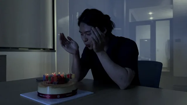 Blowing out the candles on a birthday cake.