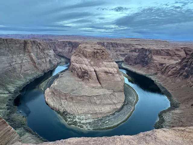 The Colorado River curving around the cliffs at Horseshoe Bend.